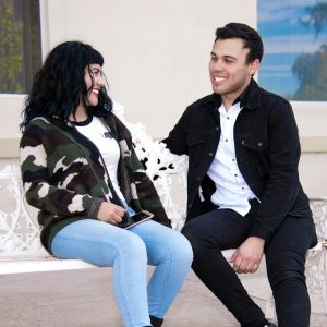 a man and a woman sitting on a bench