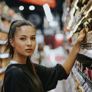 woman selecting packed food on gondola