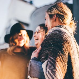 people laughing and talking outside during daytime